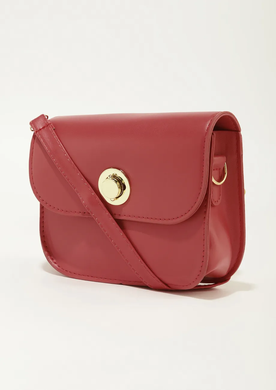A LITTLE STATEMENT RED SLING BAG